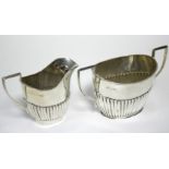 A George V oval semi-fluted two-handled sugar bowl, Chester 1911 by Barker Bros.; & a ditto 3½” milk