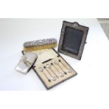 A rectangular photograph frame with embossed border, 7" x 5.25", London 1990; a set of