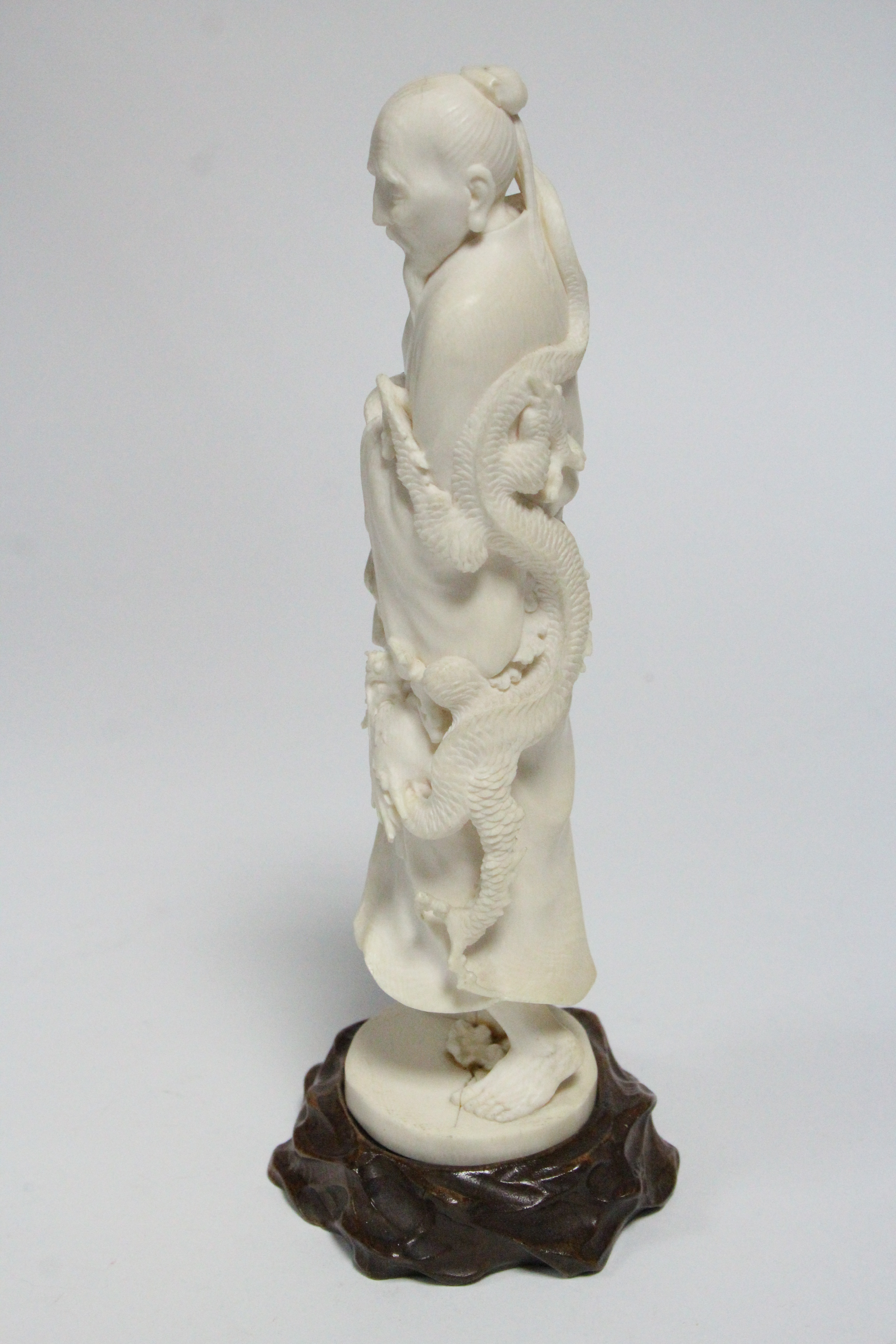 A late 19th century Japanese ivory okimono of a standing male scholar holding a scroll & a staff, - Image 4 of 5