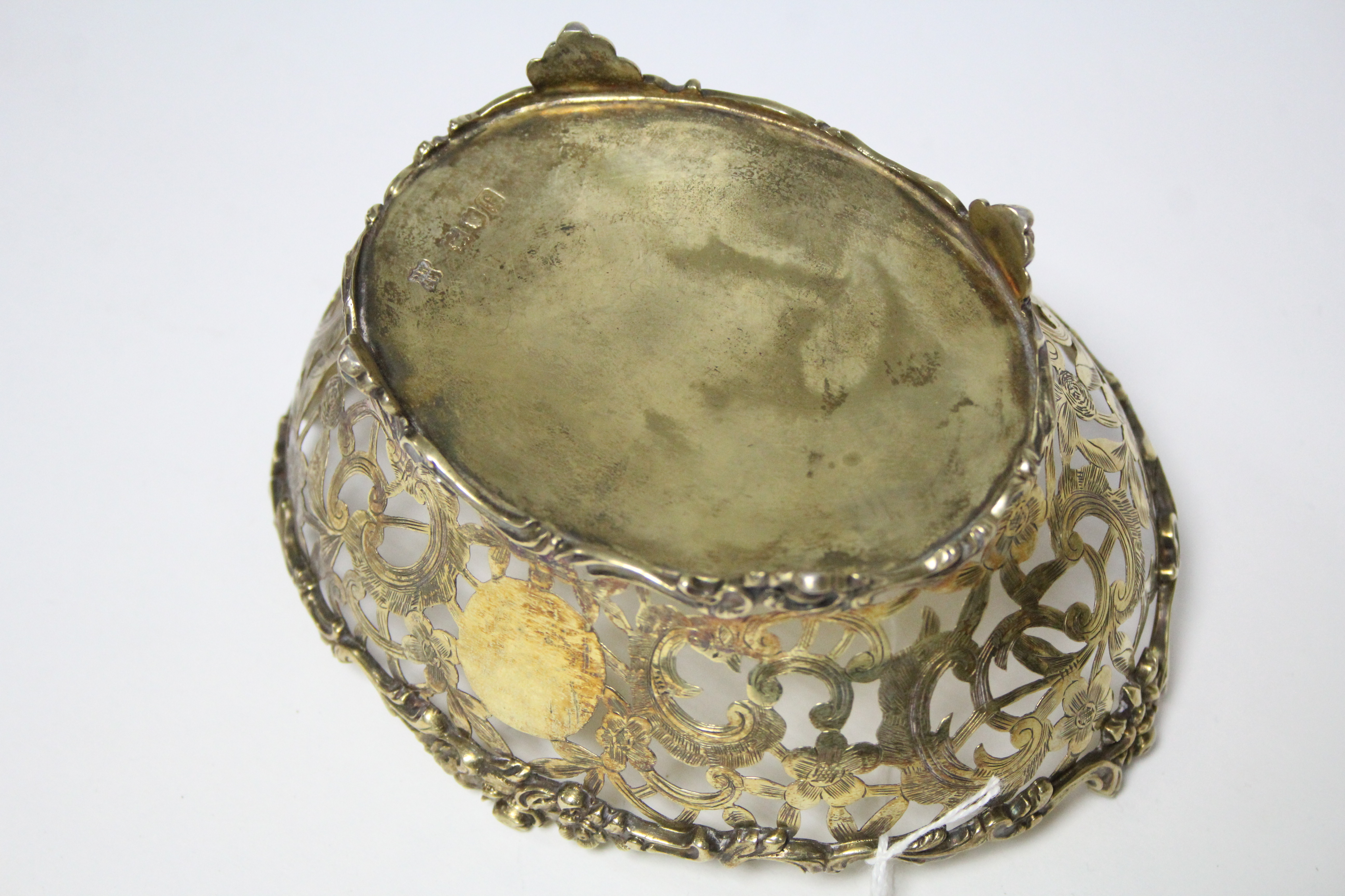 An Edwardian silver-gilt pierced oval dish with shaped cast scroll rim & feet, & engraved flower & - Image 2 of 3