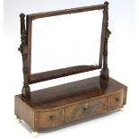 An early 19th century inlaid-mahogany rectangular swing toilet mirror with turned supports, the