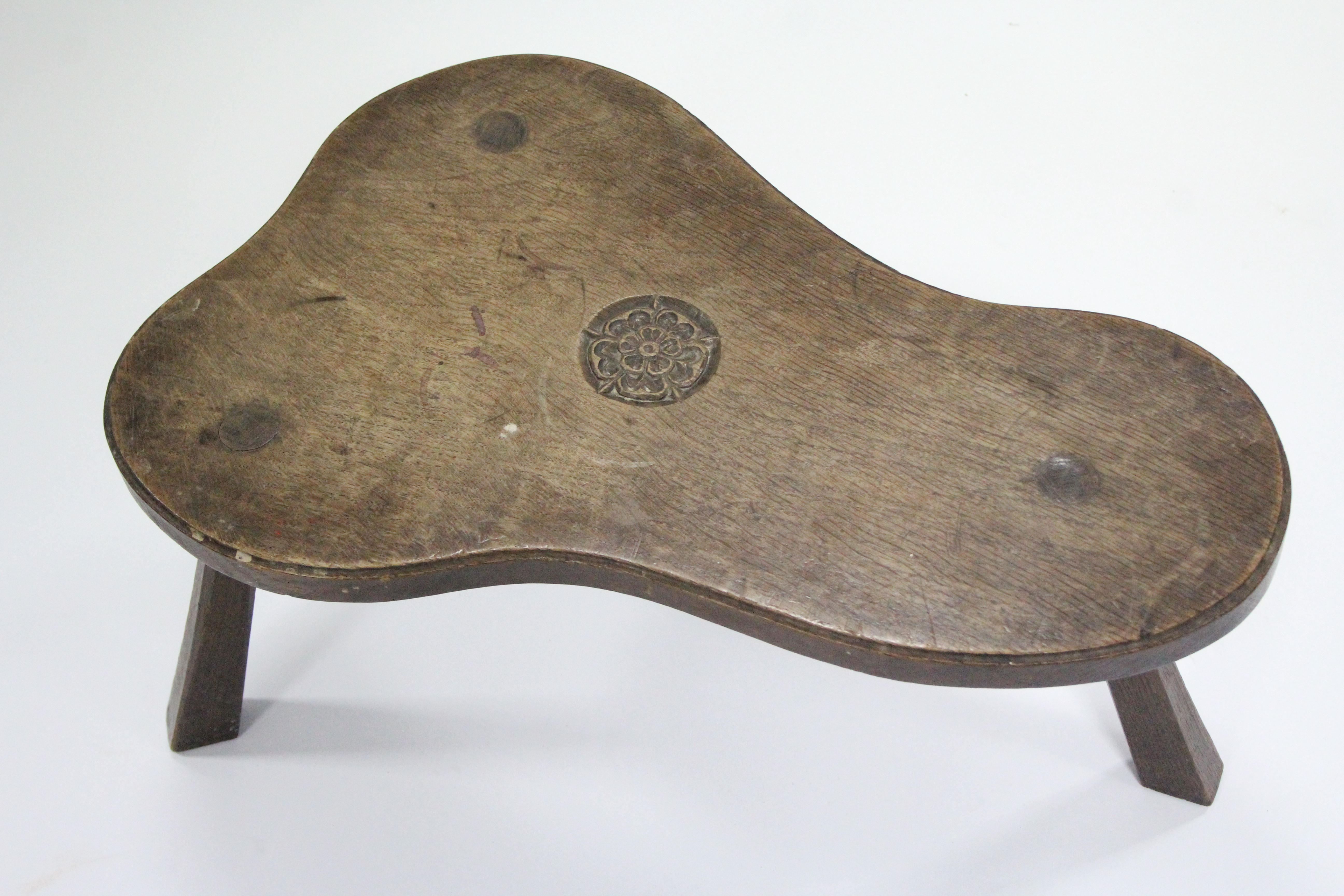 An oak milking stool by JACK GRIMBLE, the shaped seat with carved Tudor rose, on three chamfered - Image 2 of 4