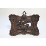 A 19th century continental finely carved boxwood wall applique in the form of a robed child