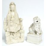 An 18th century Chinese blanc-de-chine group of Guanyin seated above a dragon with an infant on