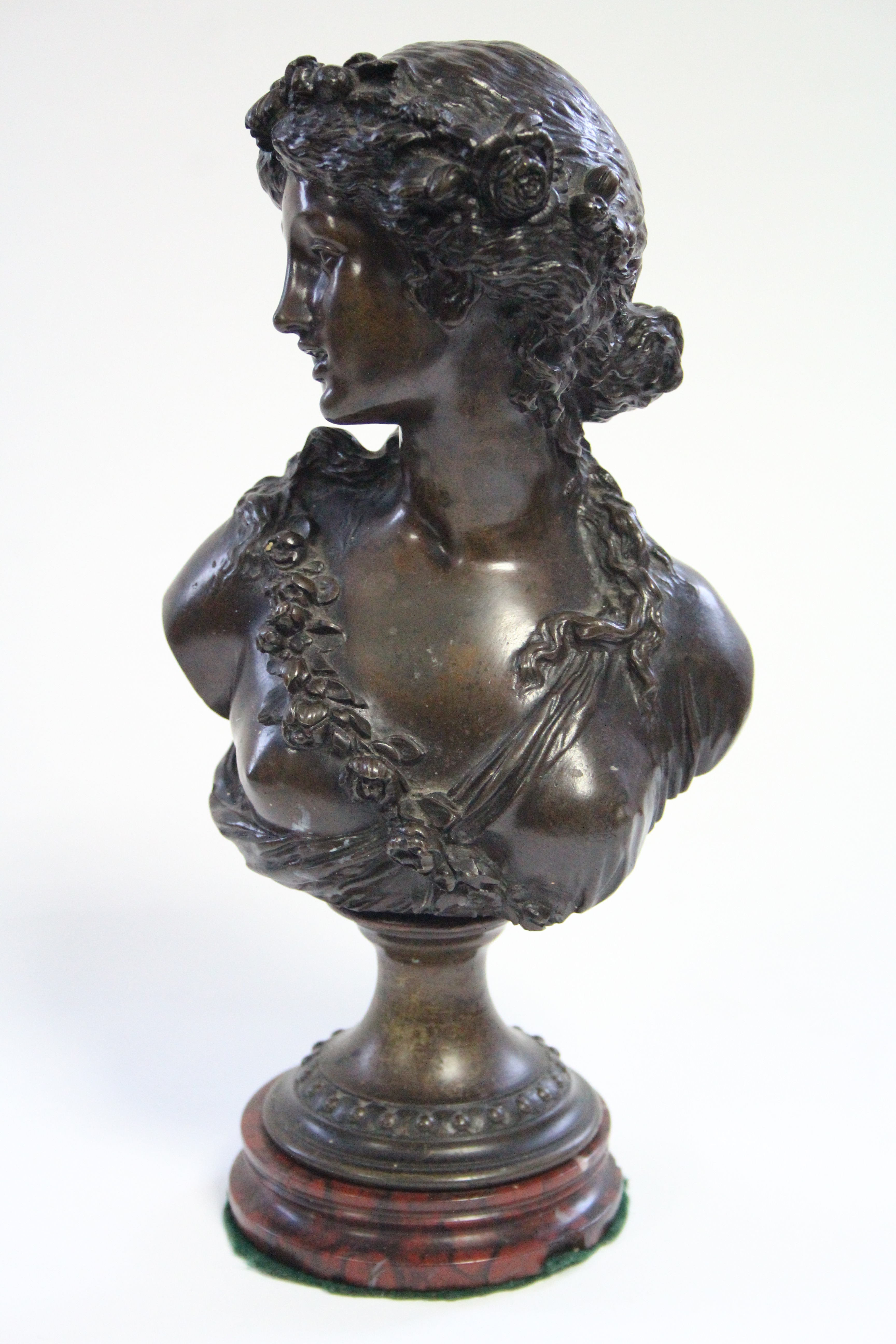 A 19th century bronze bust of a young woman with floral garland in her hair, on round socle & - Image 2 of 4