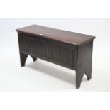 A late 19th century oak coffer with hinged lift-lid, linen-fold panel front, & on shaped end