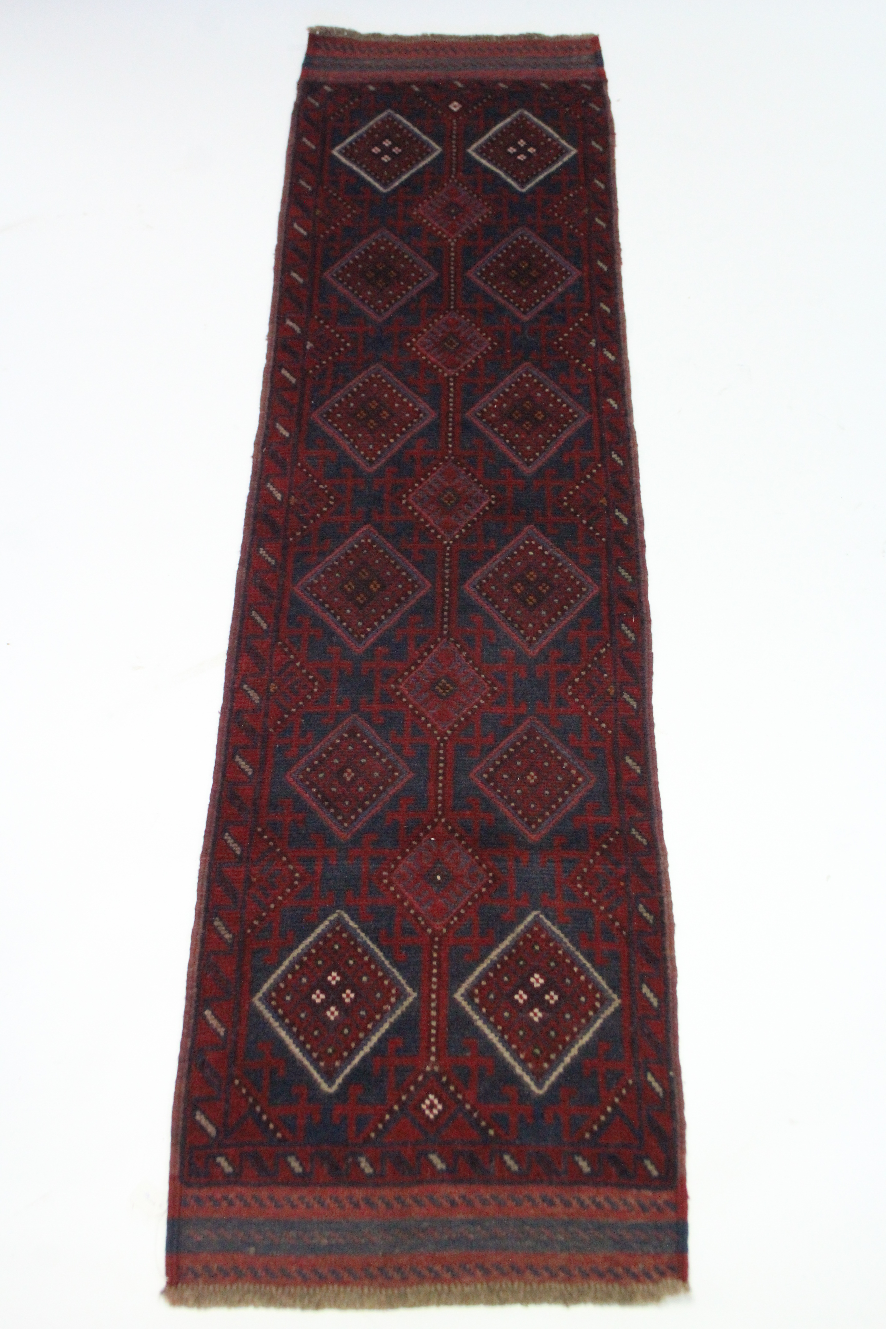 A Meshwari runner of deep blue, crimson, & ivory ground with two rows of six & one row of five