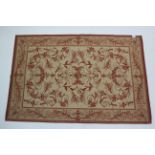 A Laura Ashley rug of cream ground & with all-over repeating crimson foliate design, 69¾” x 46”; & a