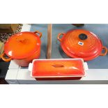A Le Creuset orange enamelled casserole dish; an aluminium fish kettle; three pestles; two