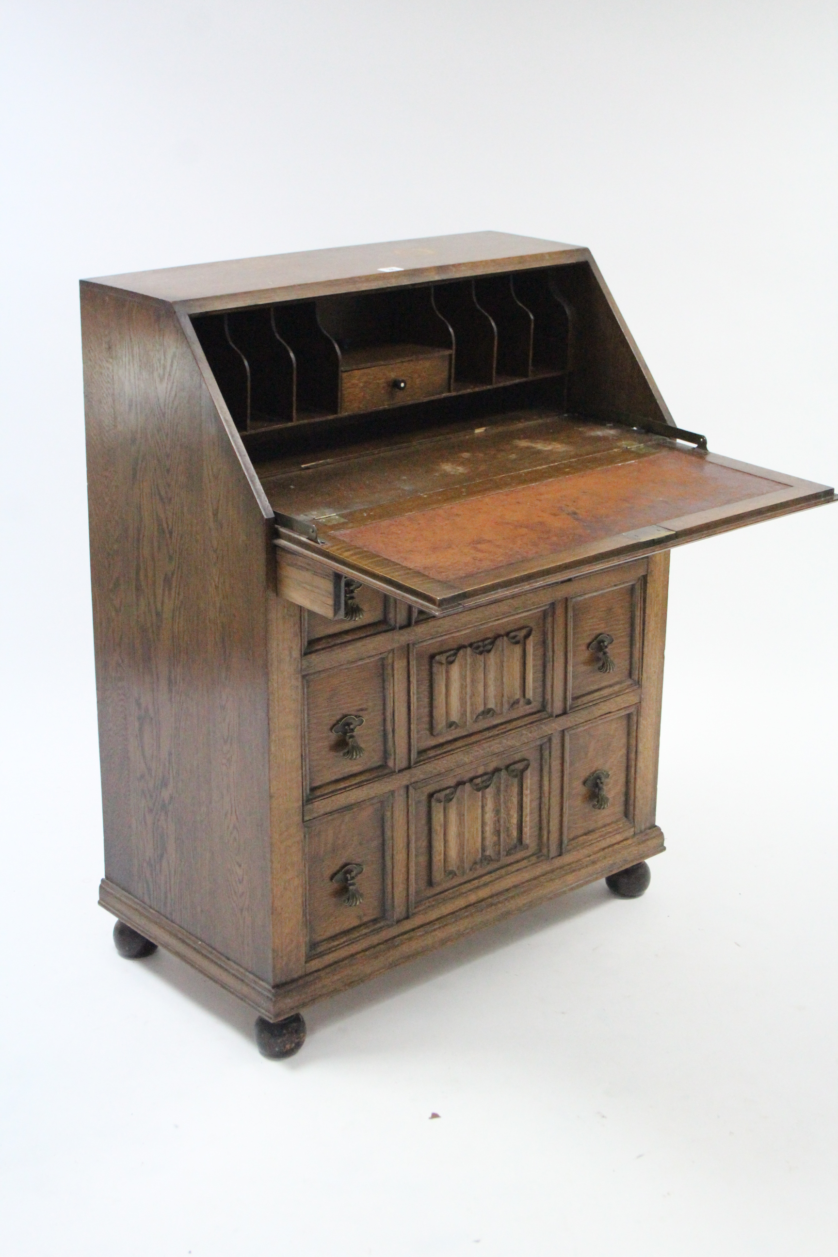 An early 20th century oak bureau with fitted interior enclosed by fall-front above three long - Image 2 of 3