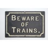 A reproduction painted cast-iron sign “BEWARE OF TRAINS”, 8¼” X 12”.