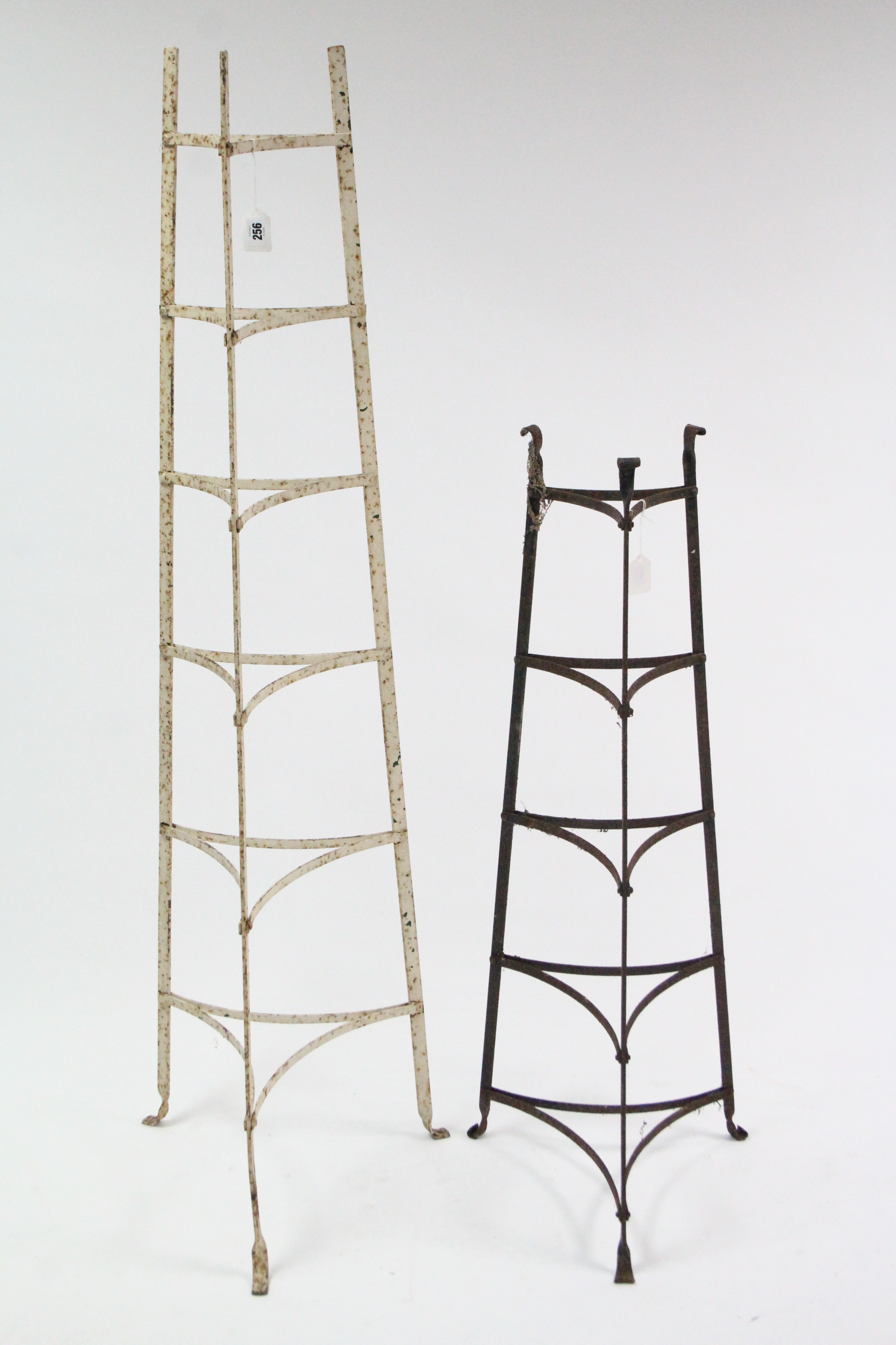 A white painted wrought-iron six-tier standing saucepan stand, 55” high; & a plain wrought-iron