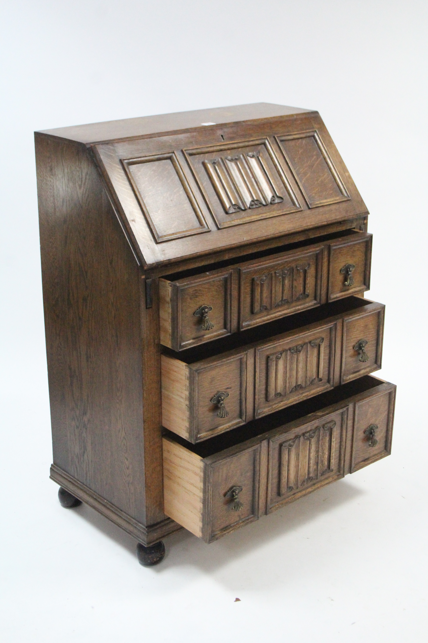 An early 20th century oak bureau with fitted interior enclosed by fall-front above three long - Image 3 of 3