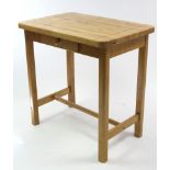 A maple-finish kitchen island with rounded corners to the rectangular top, fitted frieze drawer, &