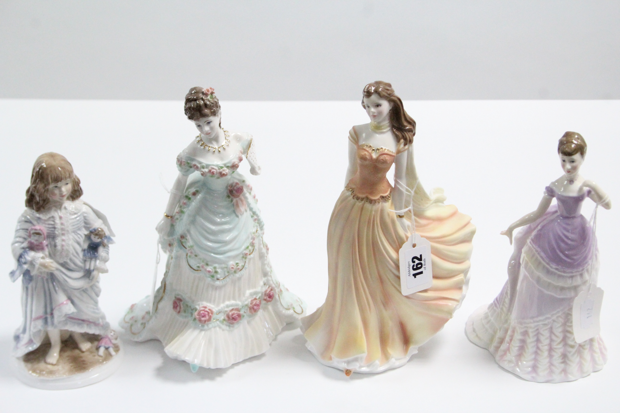 Four Royal Worcester bone china figures “A Royal Anniversary”, “Emily”, “Lullaby”, & “Wistful”.