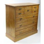 A LATE VICTORIAN MAPLE & CO ASH CHEST fitted with an arrangement of five short & three long