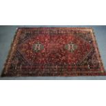 A Persian rug of blue, crimson & ivory ground; & with all-over repeating geometric design, 9’ x