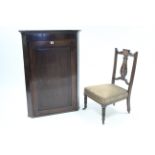 A 19th century inlaid-mahogany hanging corner cupboard fitted three shelves enclosed by panel