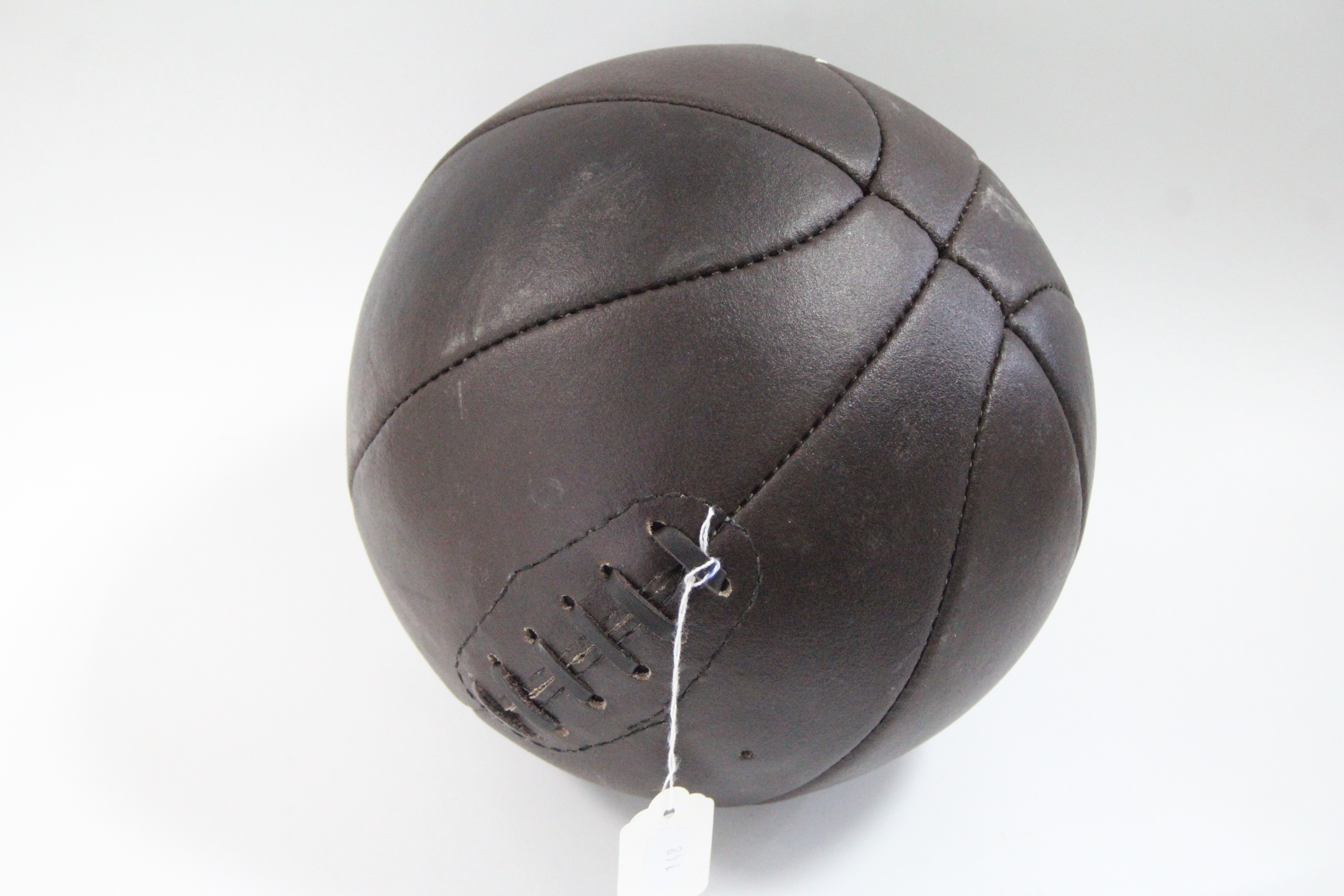 A reproduction leather football, 8½” diameter.