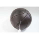 A reproduction leather football, 8½” diameter.