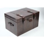 A large tan leather storage trunk with hinged lift-lid & with leather side handles, 36” wide x 21”