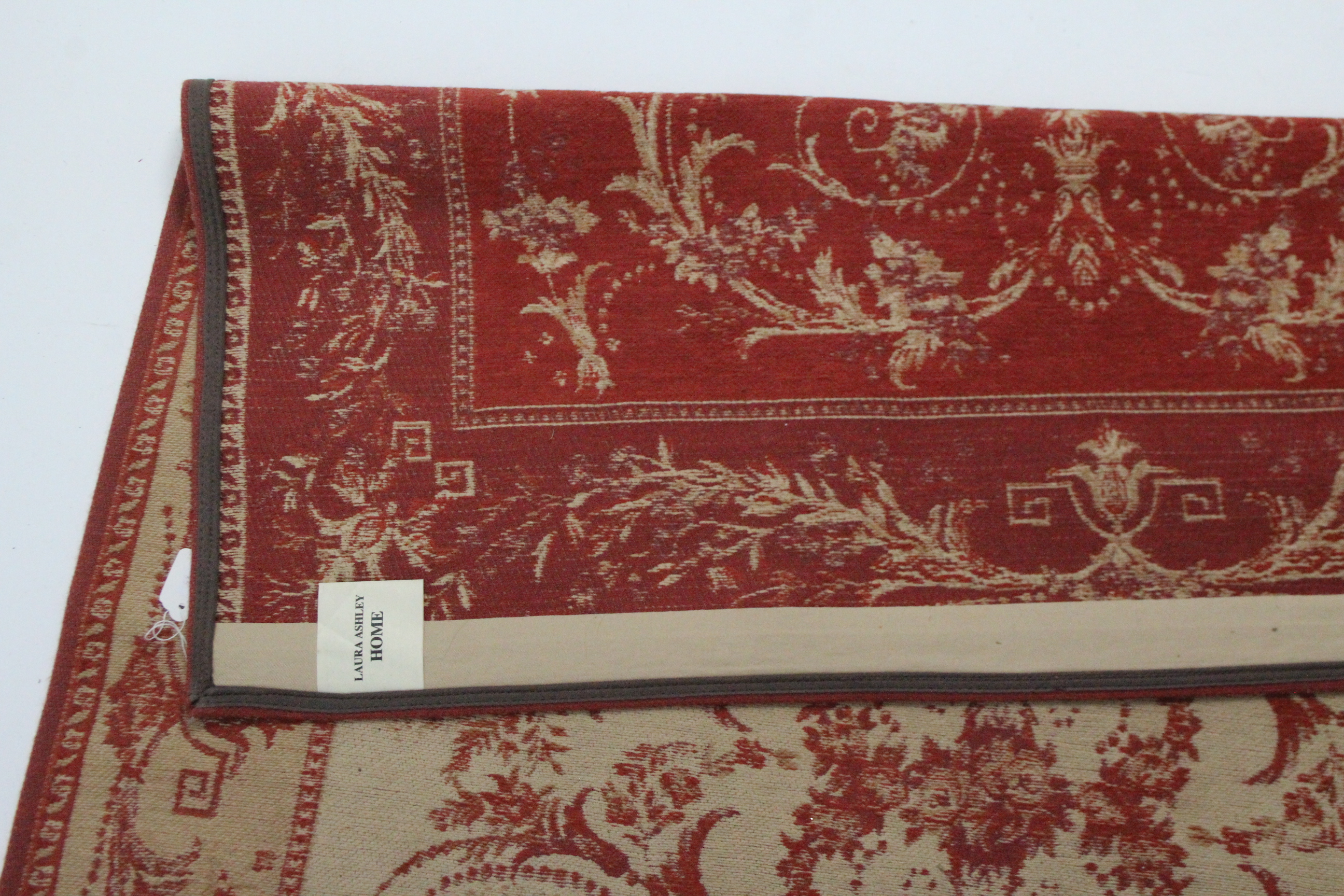 A Laura Ashley rug of cream ground & with all-over repeating crimson foliate design, 69¾” x 46”; & a - Image 2 of 3