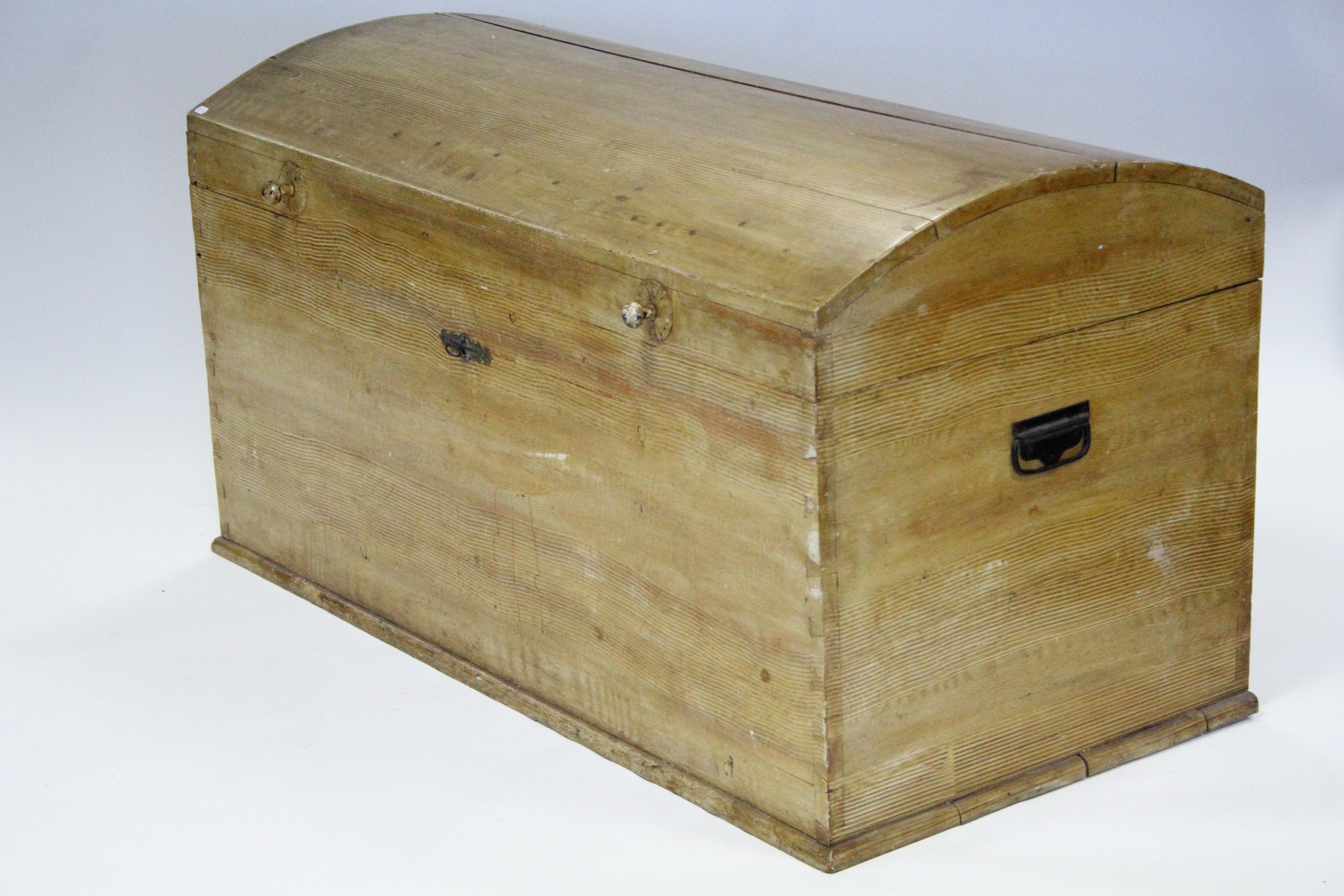 A 19th century grained pine large trunk with domed lid; 55” wide.