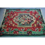 A Kelim small carpet of crimson & green ground, with multi-coloured centre medallion, & with all