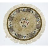 A Chinese silk circular rug with coloured decoration of birds on a fawn ground; 36” diam.