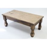 A pine rectangular low coffee table on short turned legs, 48” wide; an oak rectangular low coffee