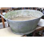 A galvanised metal oval two-handled footbath; a ceramic corner sink & accessories; & various tools.