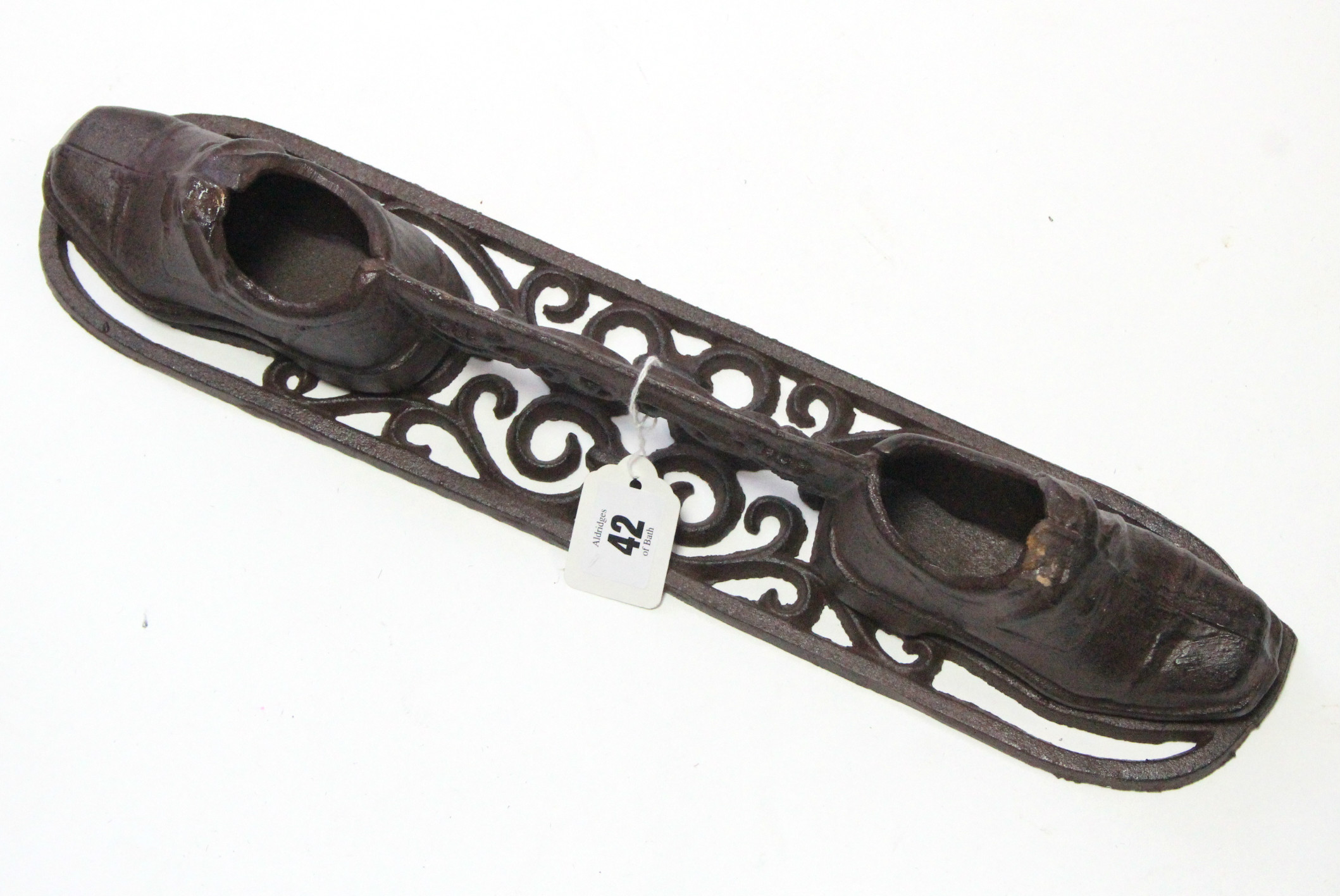 A modern cast-iron boot scrapper, 17” long.