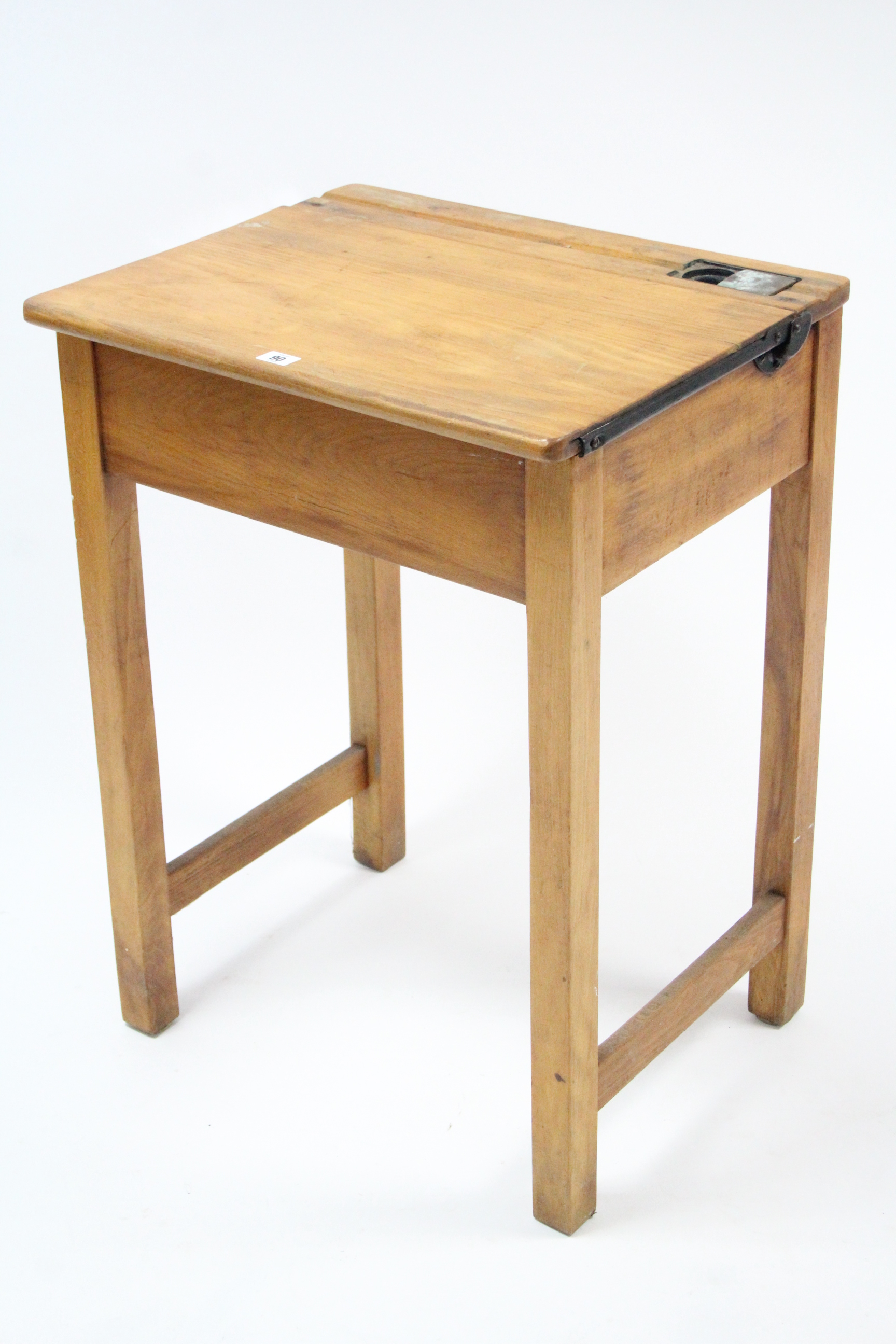 A small pine child’s school desk with hinged lift-top, & on square legs, 22” wide.