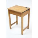 A small pine child’s school desk with hinged lift-top, & on square legs, 22” wide.