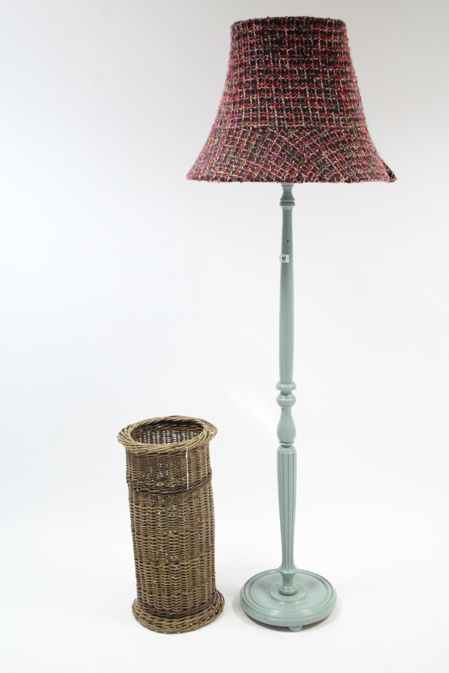 A pale blue painted wooden standard lamp with shade; & a woven-cane cylindrical umbrella stand.
