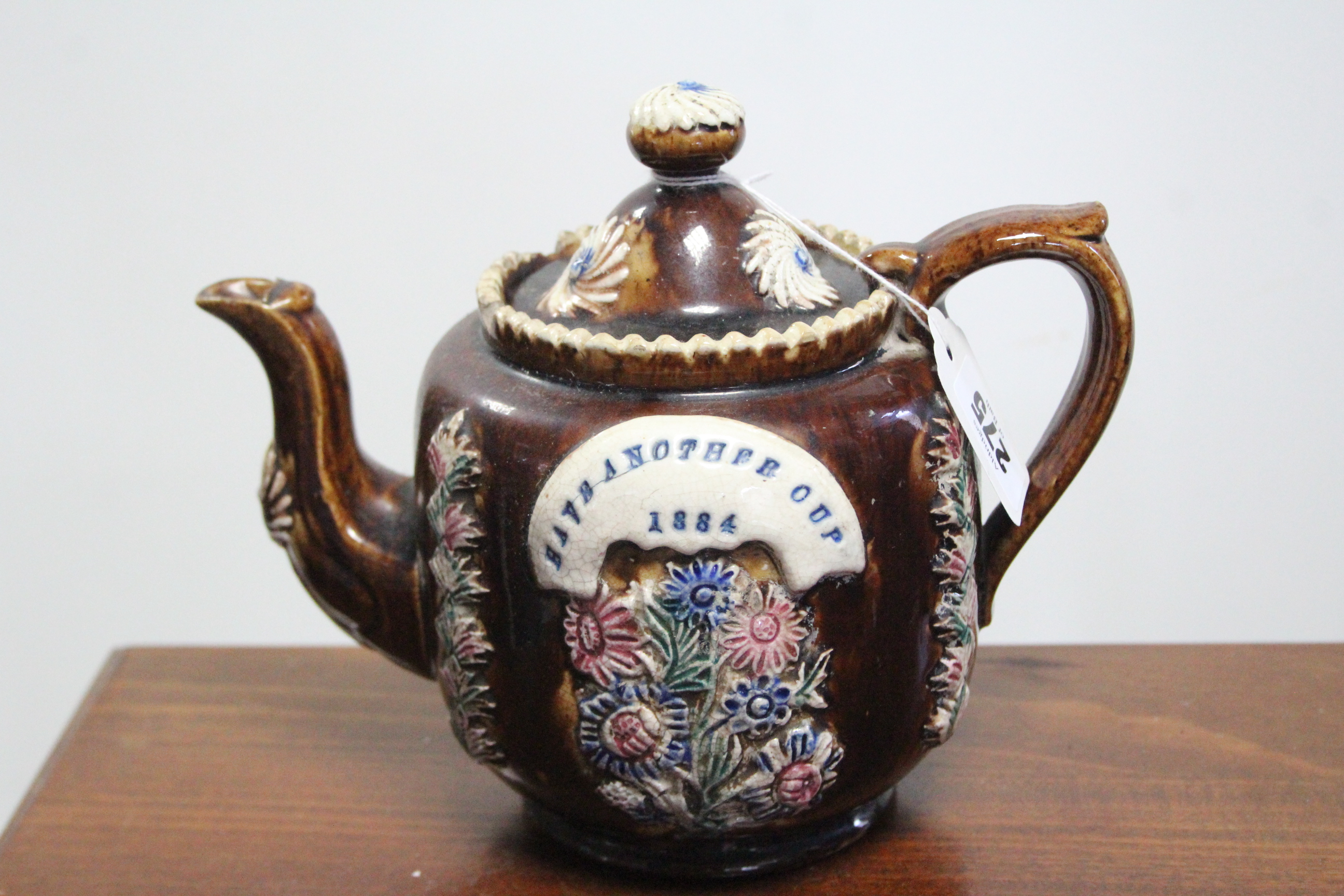 A late 19th century treacle glazed barge ware teapot (1884), 6¾” high; a Quimper ware jardinière, 6”