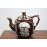 A late 19th century treacle glazed barge ware teapot (1884), 6¾” high; a Quimper ware jardinière, 6”