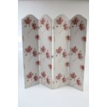 A four-fold tall draught screen upholstered floral material, 67¼” high.