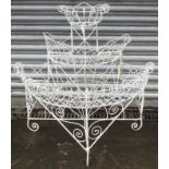A Victorian white painted wrought-iron demi-lune three-tier plant stand, 36” wide x 35½” high.