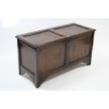 A reproduction oak coffer with panelled hinged lift-lid & with panelled front & sides, 44” wide.