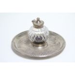 A late Victorian cut-glass globular inkwell mounted on wide silver base & with silver cover, 3”