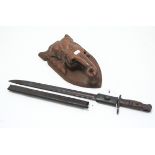 A rifle bayonet (sheath w.a.f.); & a carved wooden elephant wall mask.