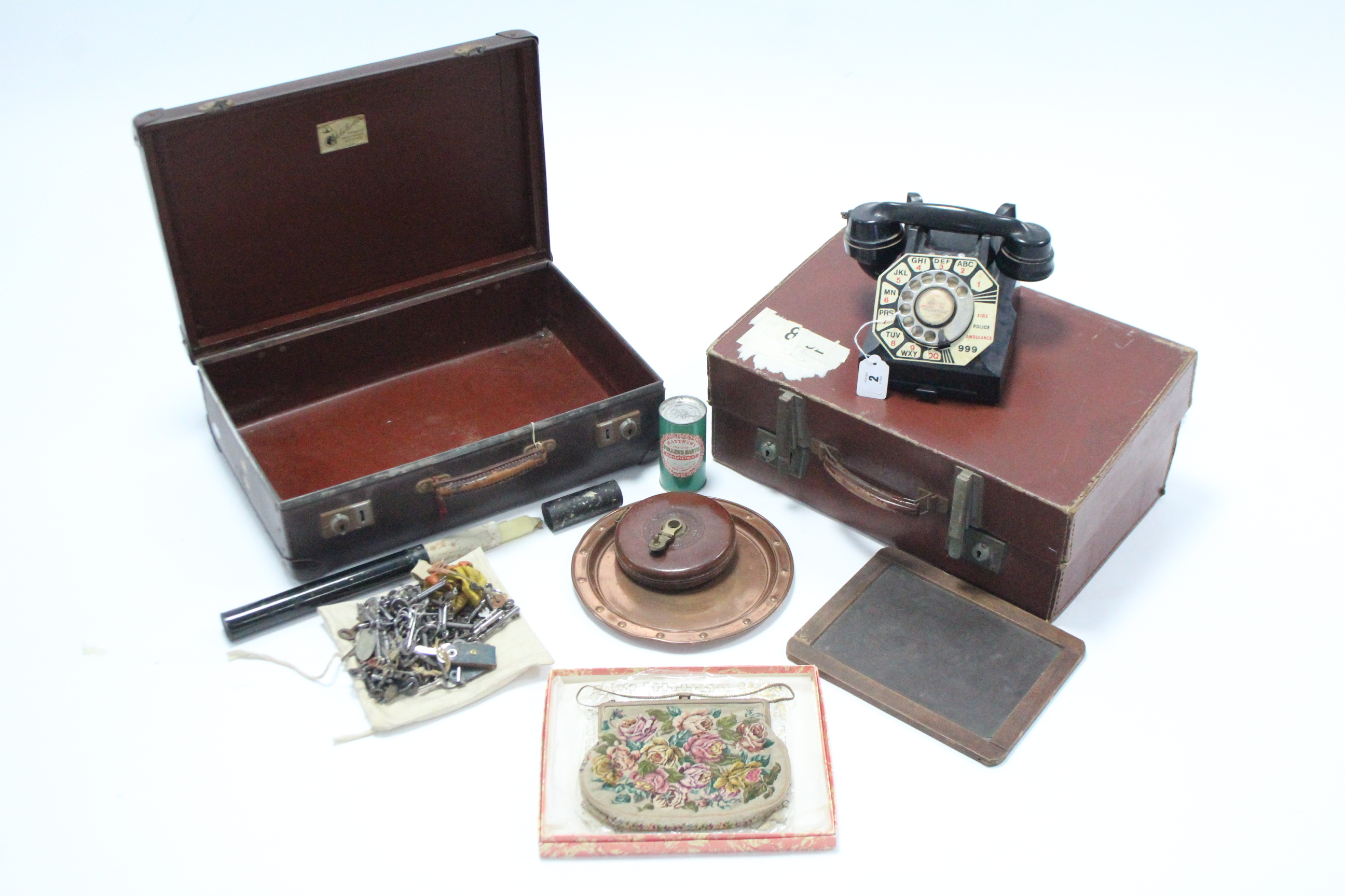 A vintage G. P. O. black Bakelite telephone; two fibre-covered suitcases; a Grown Brand child’s