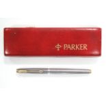 A Parker fountain pen, in engine-turned sterling silver case & with 14ct. gold nib; 5” long.