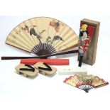 A Japanese cloth hand puppet in glazed deal case; two Japanese fans; & a pair of Japanese sandals.