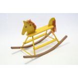 A yellow painted wood rocking horse, 23” high.