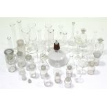 Approximately thirty various clear glass laboratory receptacles.