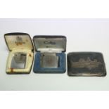 A Ronson cigarette lighter; a Calibri ditto, both cased; & a silver plated cigarette case.