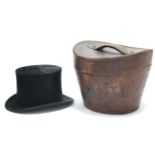 A Dunn & Co. of London black silk top hat (size 7) with a leather oval hatbox.