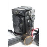 A Yashica “Mat 124 G” twin lens box camera with leather case; together with three tripods &